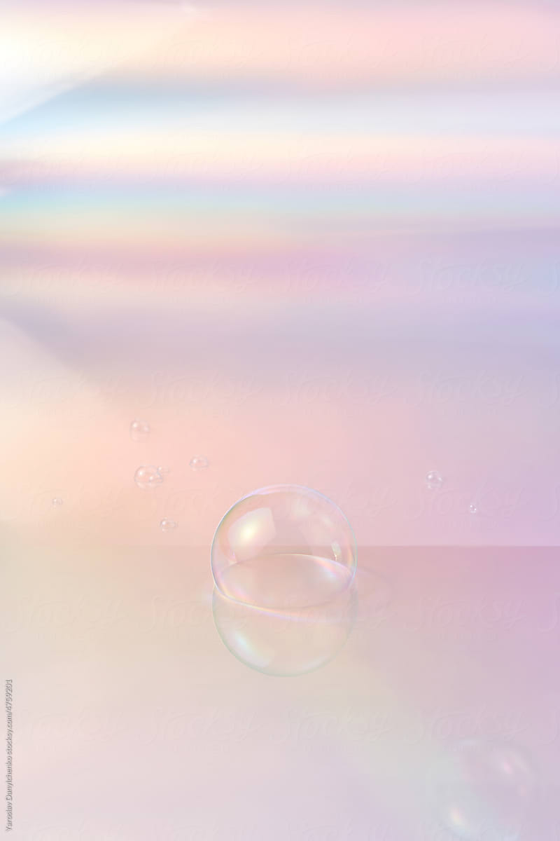 Soap bubbles on glossy pink background.