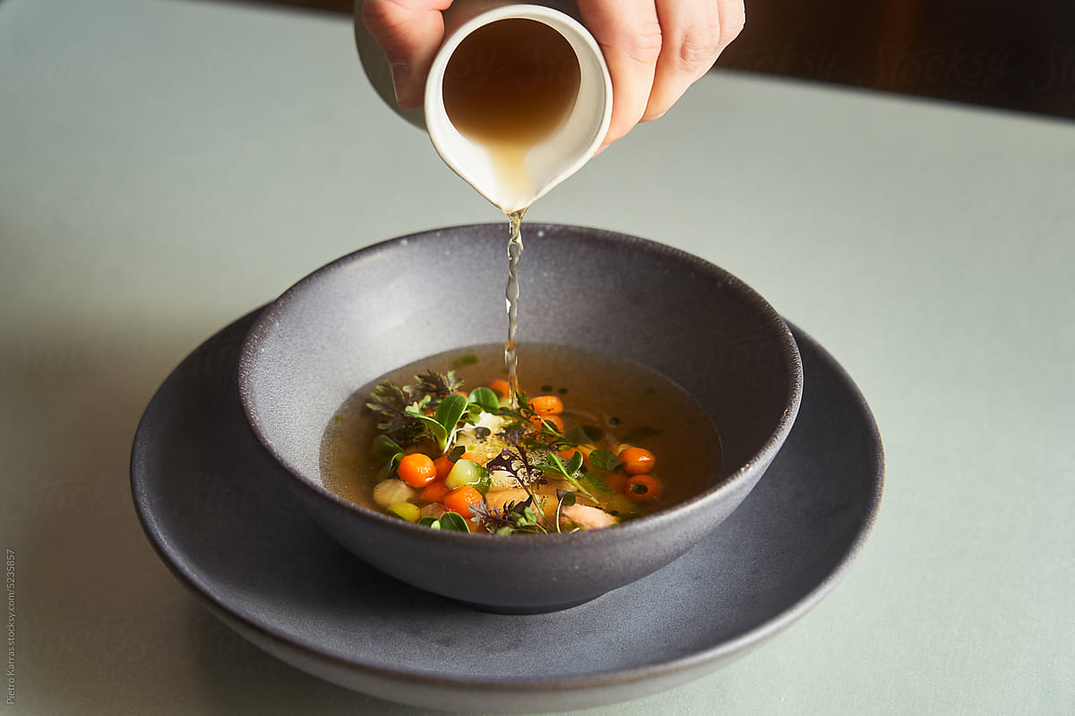 Chef pouring soup in fine dining restaurant