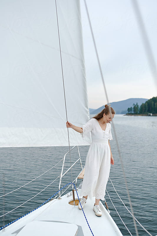 Beautiful Girl Travel Yacht In A White Dress." by Stocksy Contributor  "Tatiana Timofeeva" - Stocksy