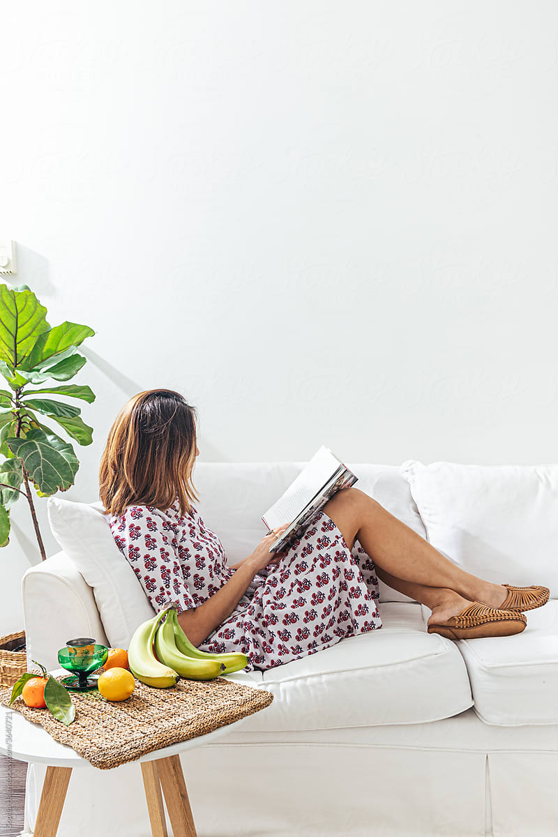 Female reading on sofa in a chic apartment