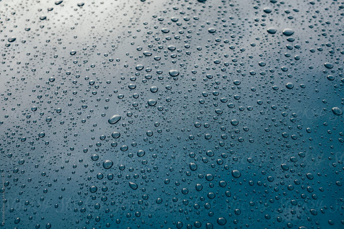 Raindrops on hood of car, close up