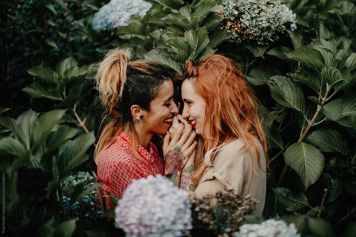 Two Girls Kissing Behind A Bush Del Colaborador De Stocksy Thais Ramos Varela Stocksy