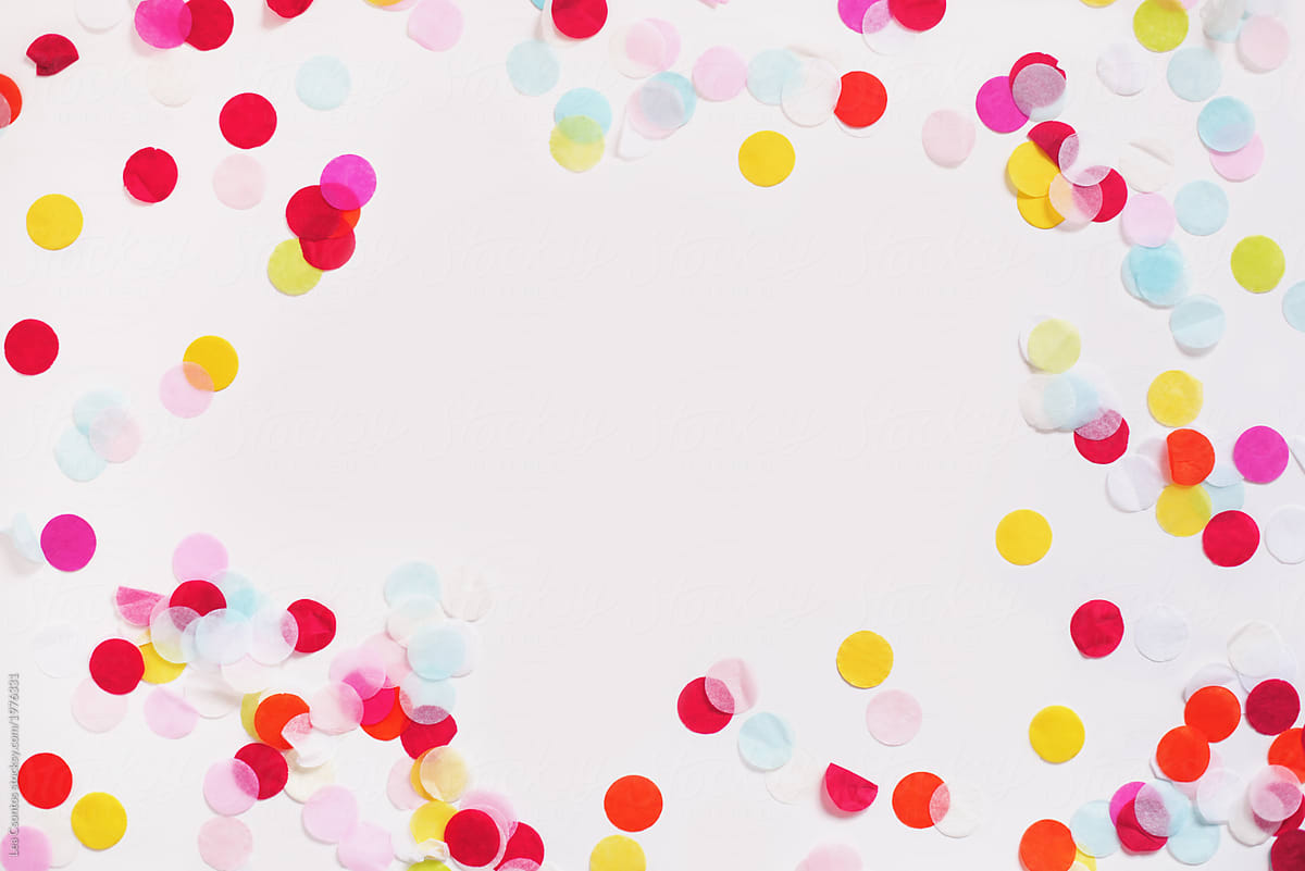 Colorful Paper Confetti Scattered Around A White Background. by