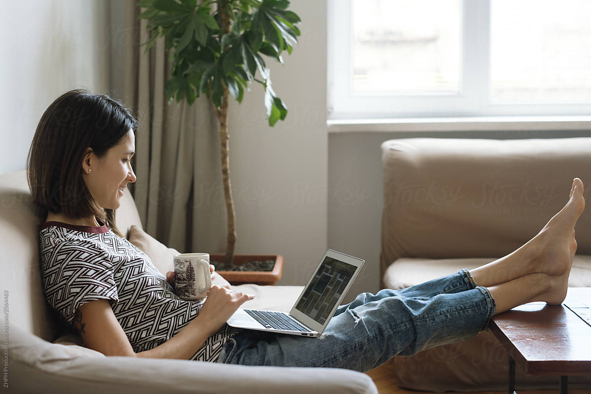 Woman browsing laptop at home