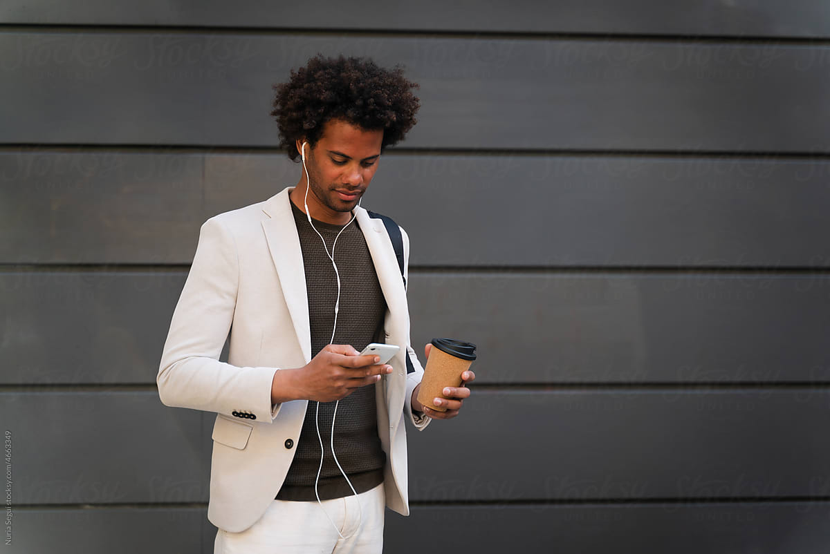 Male Entrepreneur Using Phone With Headphones