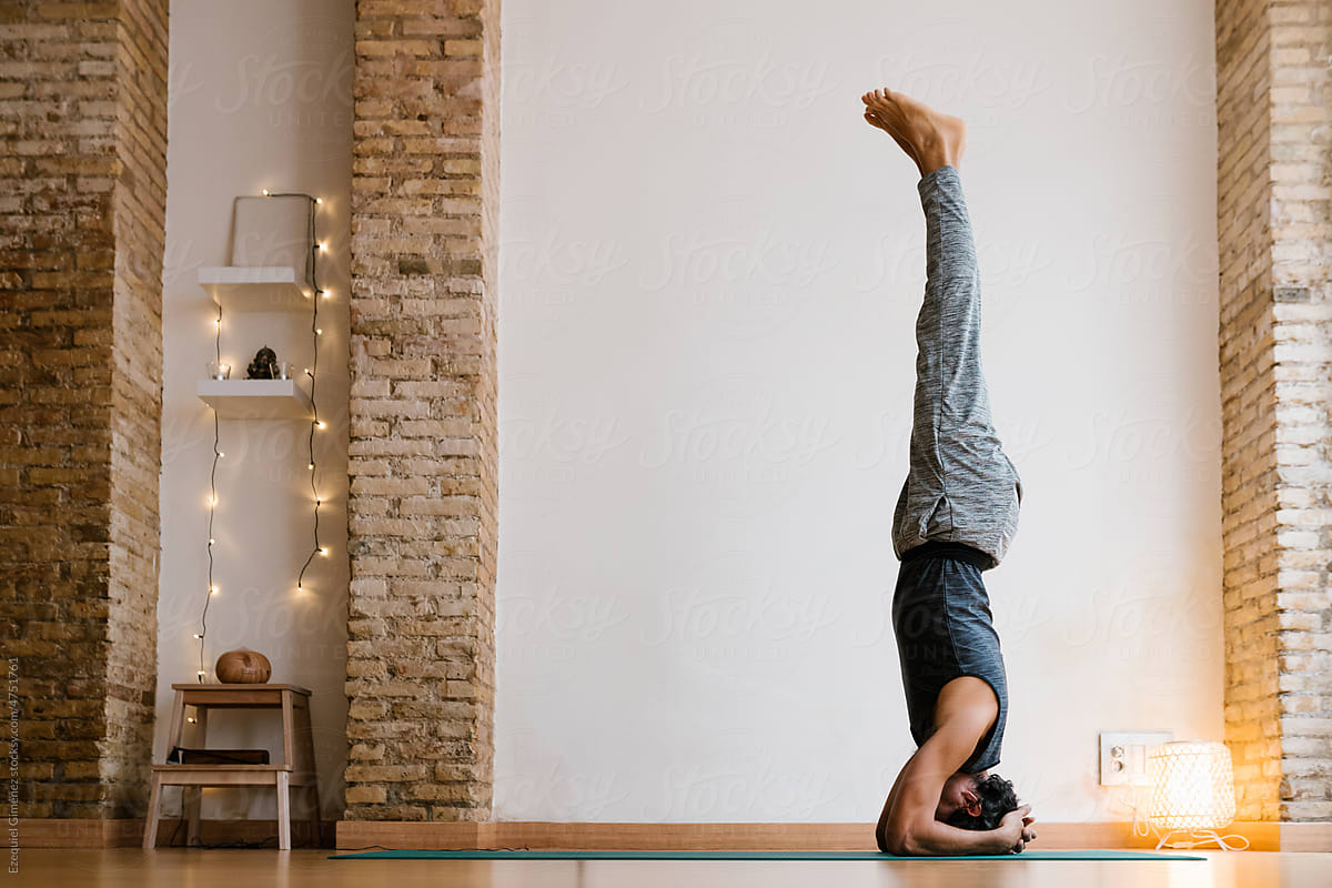 Sportive man practicing Supported headstand