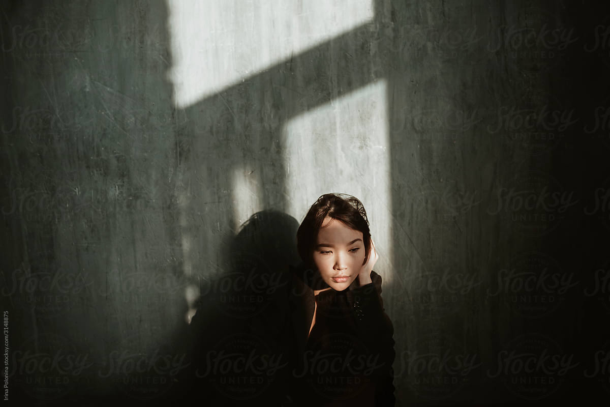Asian girl in a dark room.