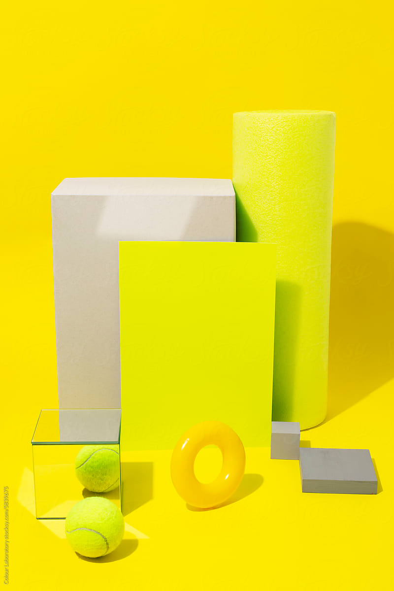 Bright neon yellow still life image of geometric objects of materials