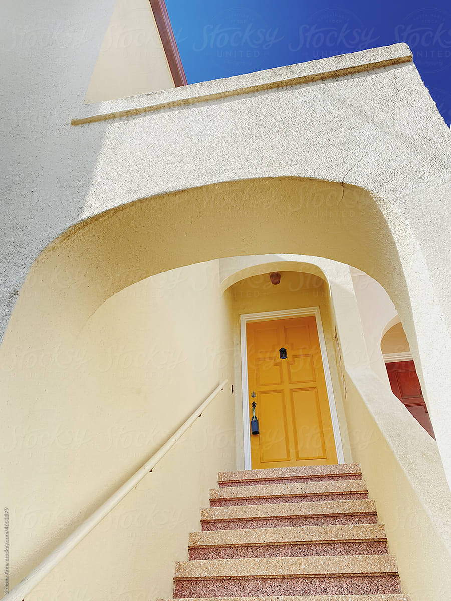 Yellow front door up some stairs