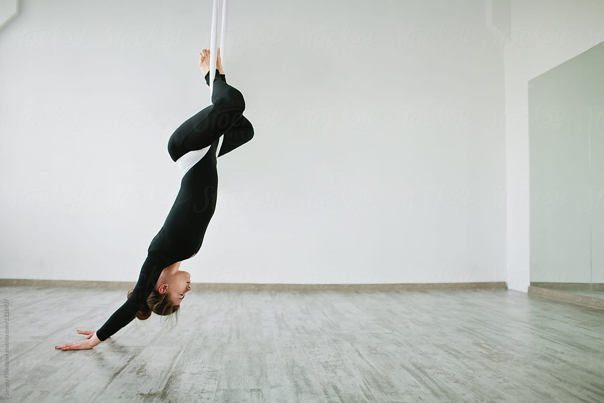 Young Woman Upside Down Doing Aerial Yoga By Stocksy Contributor Sergey Filimonov Stocksy 1116