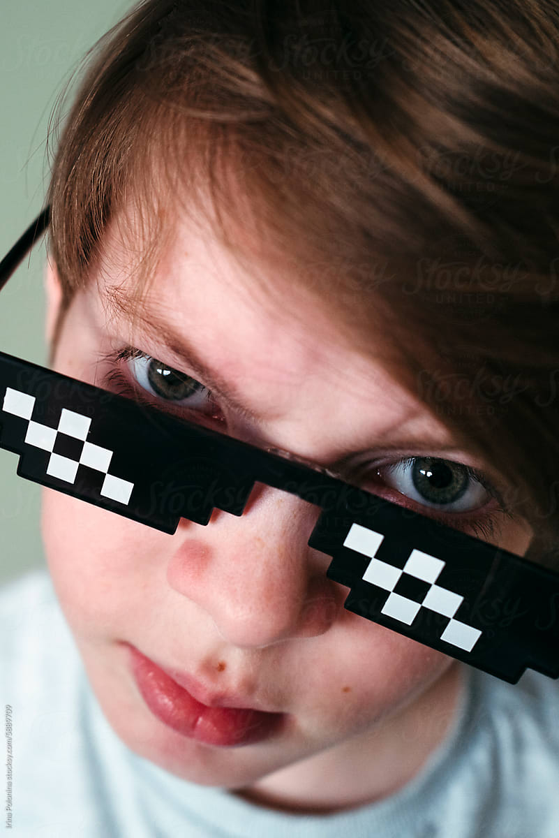 Closeup teen boy in pixel sunglasses.