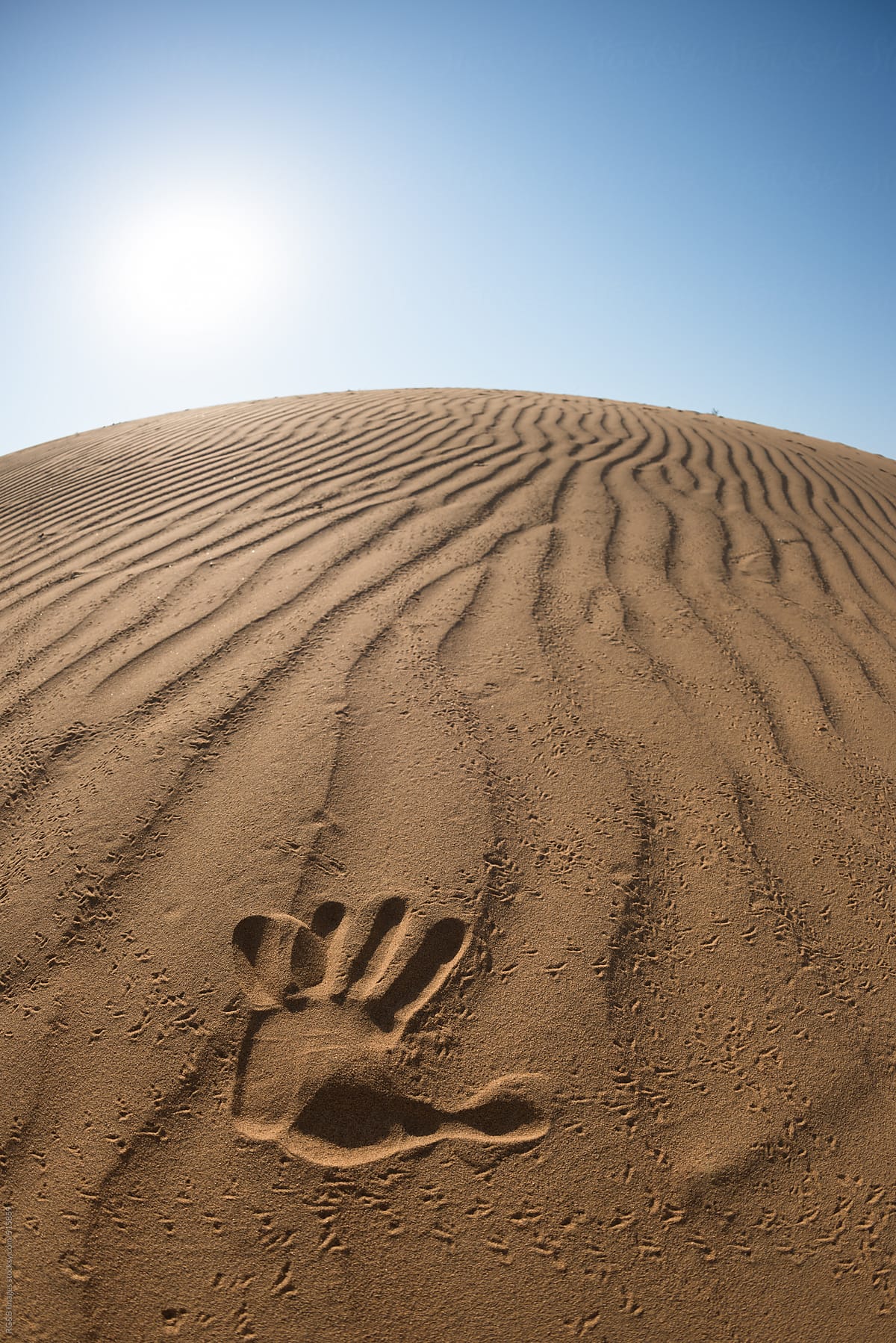 hand print on the desert sand