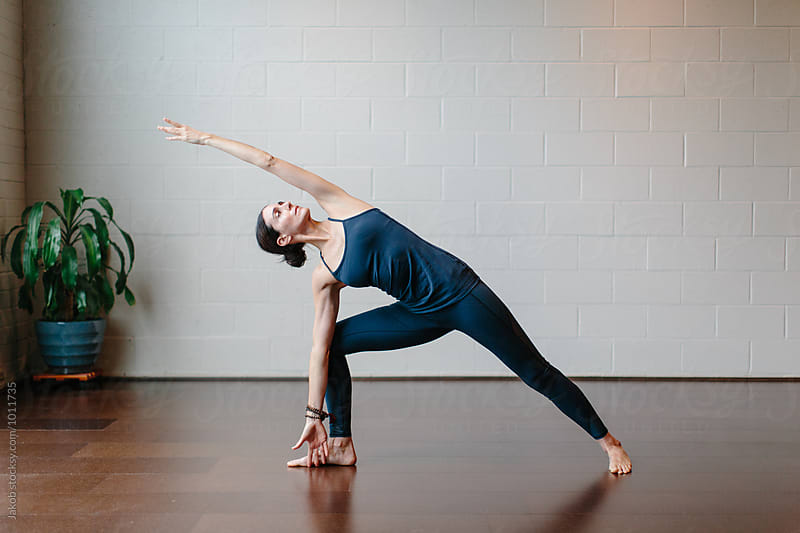 Beautiful woman practicing yoga in a studio