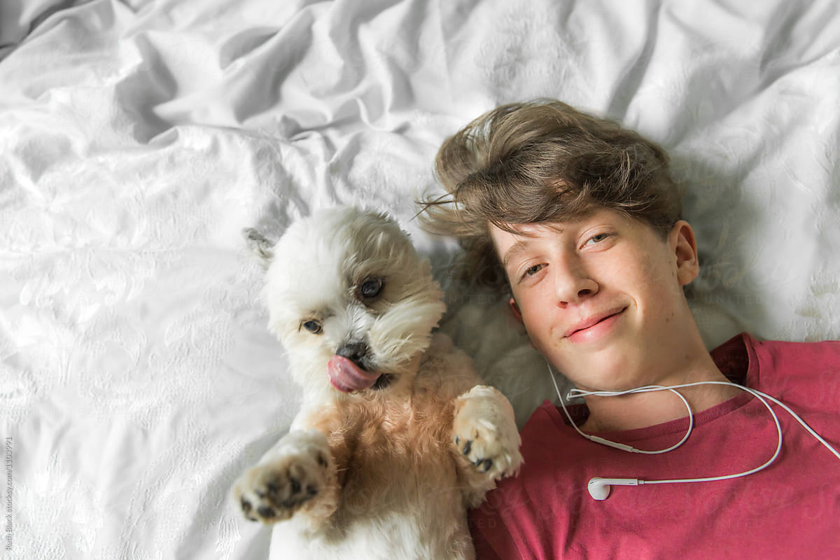Teenage boy relaxing with his dog