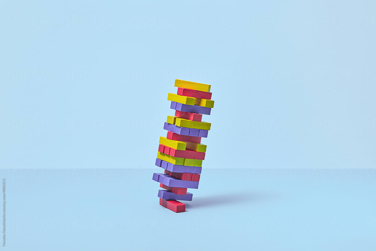 Falling tower game made of wooden multicolored blocks
