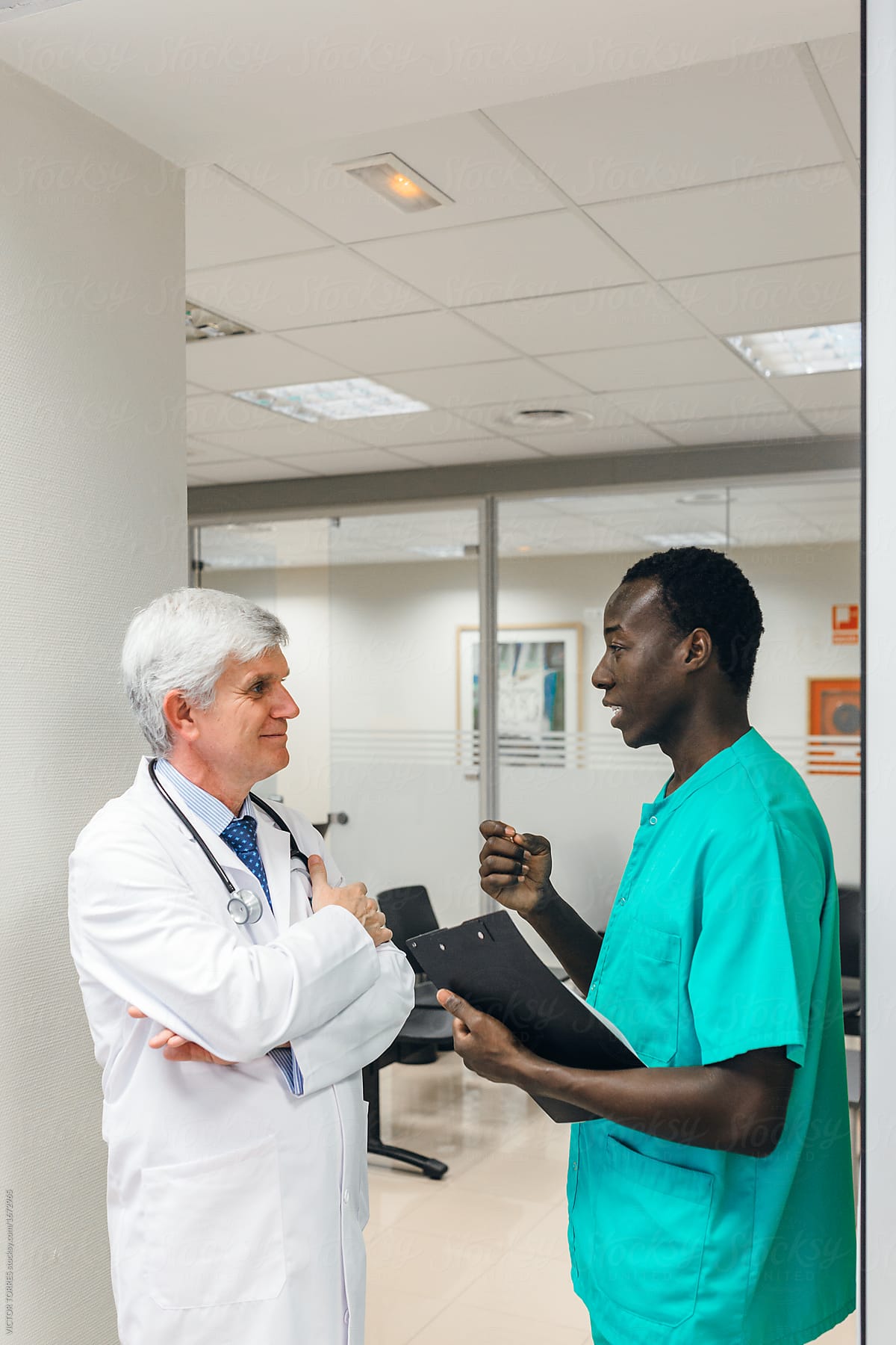 Doctors standing and communicating in hospital.