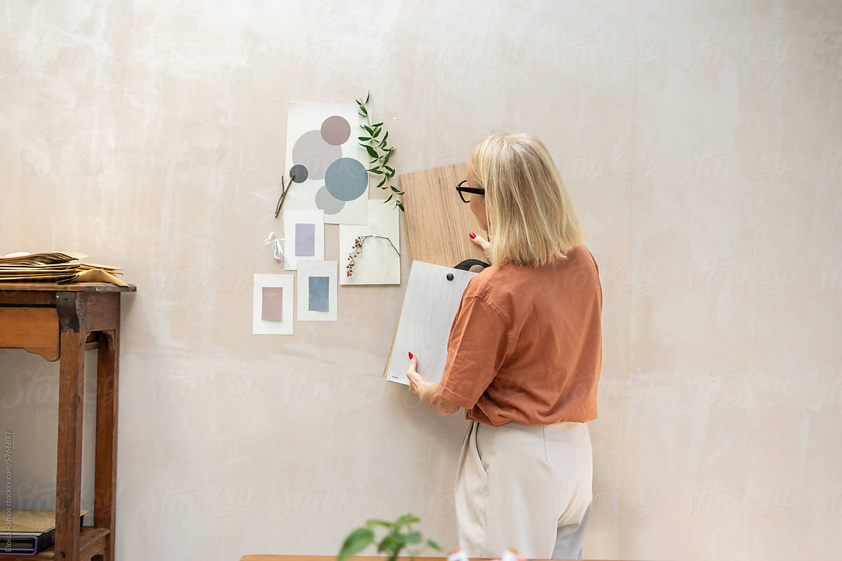 mature woman working at home studio in a home decor project