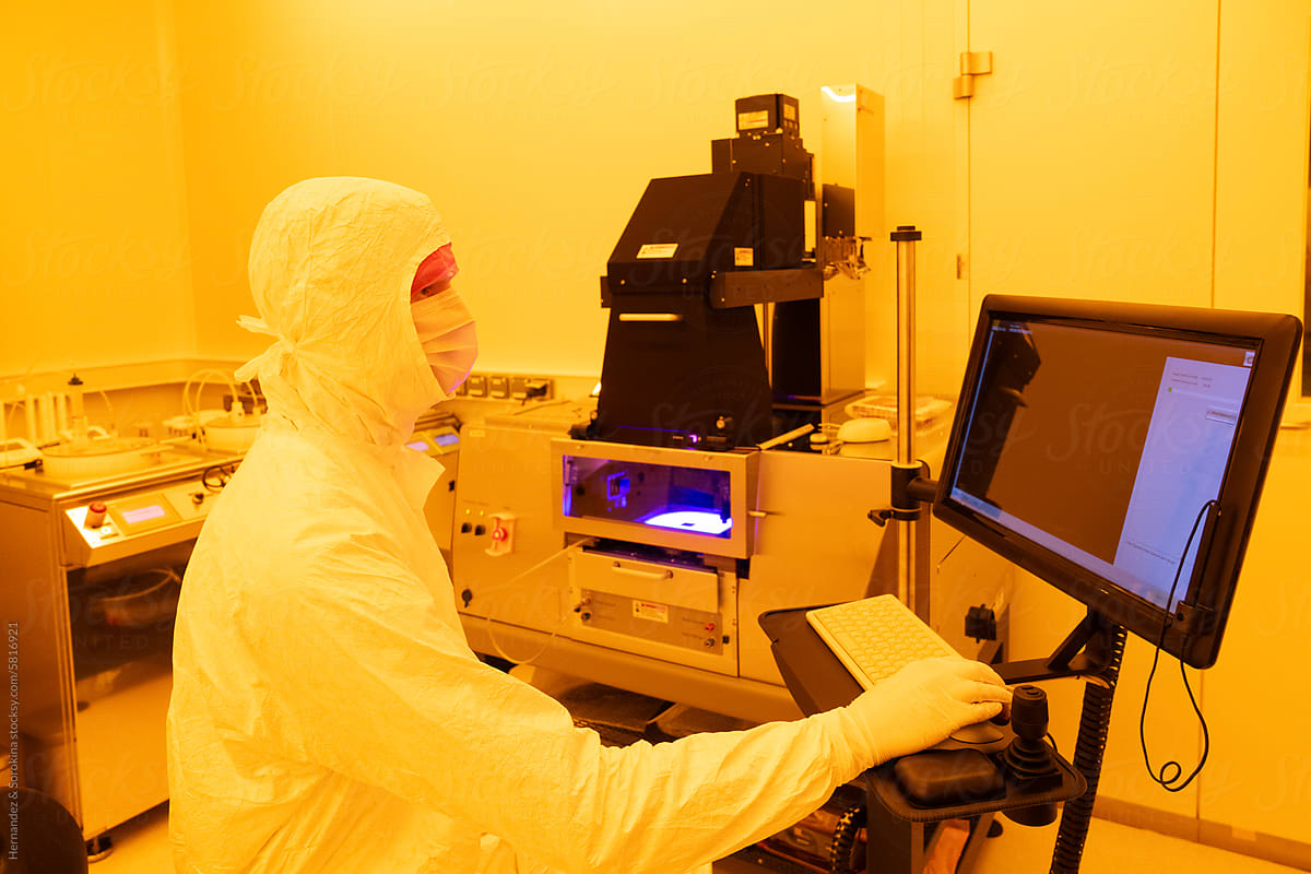 Researcher Using Computer In Clean Room