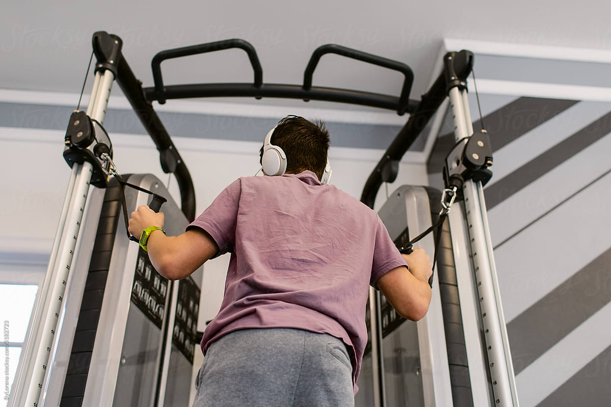 Teenager Boy muscle-building At Fit Gym