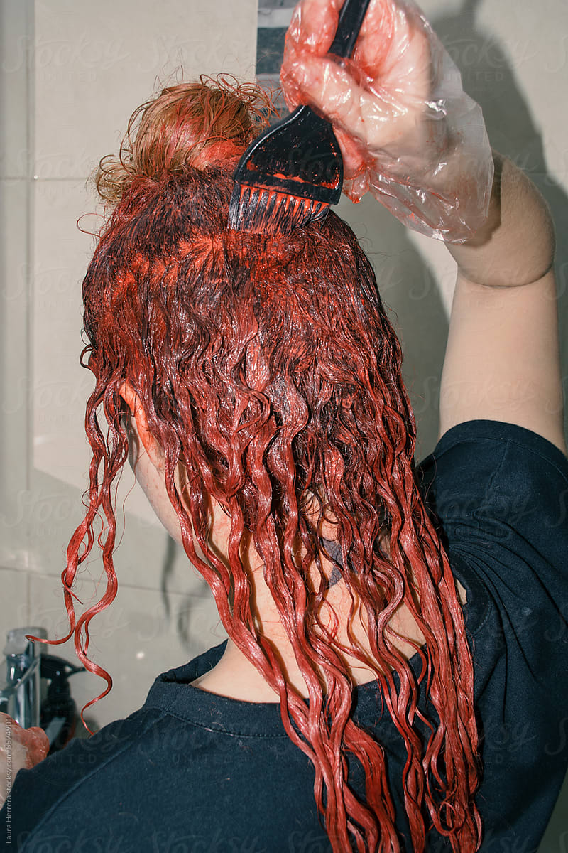 Woman dyeing her hair red