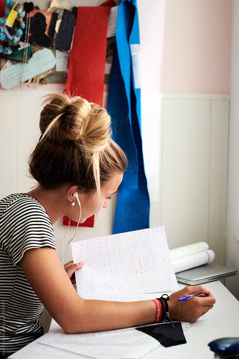 Woman doing homework at desk at home.