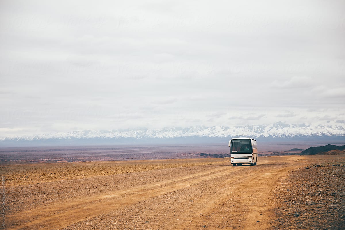 Tourist bus driving in a steppe, Kazakhstan