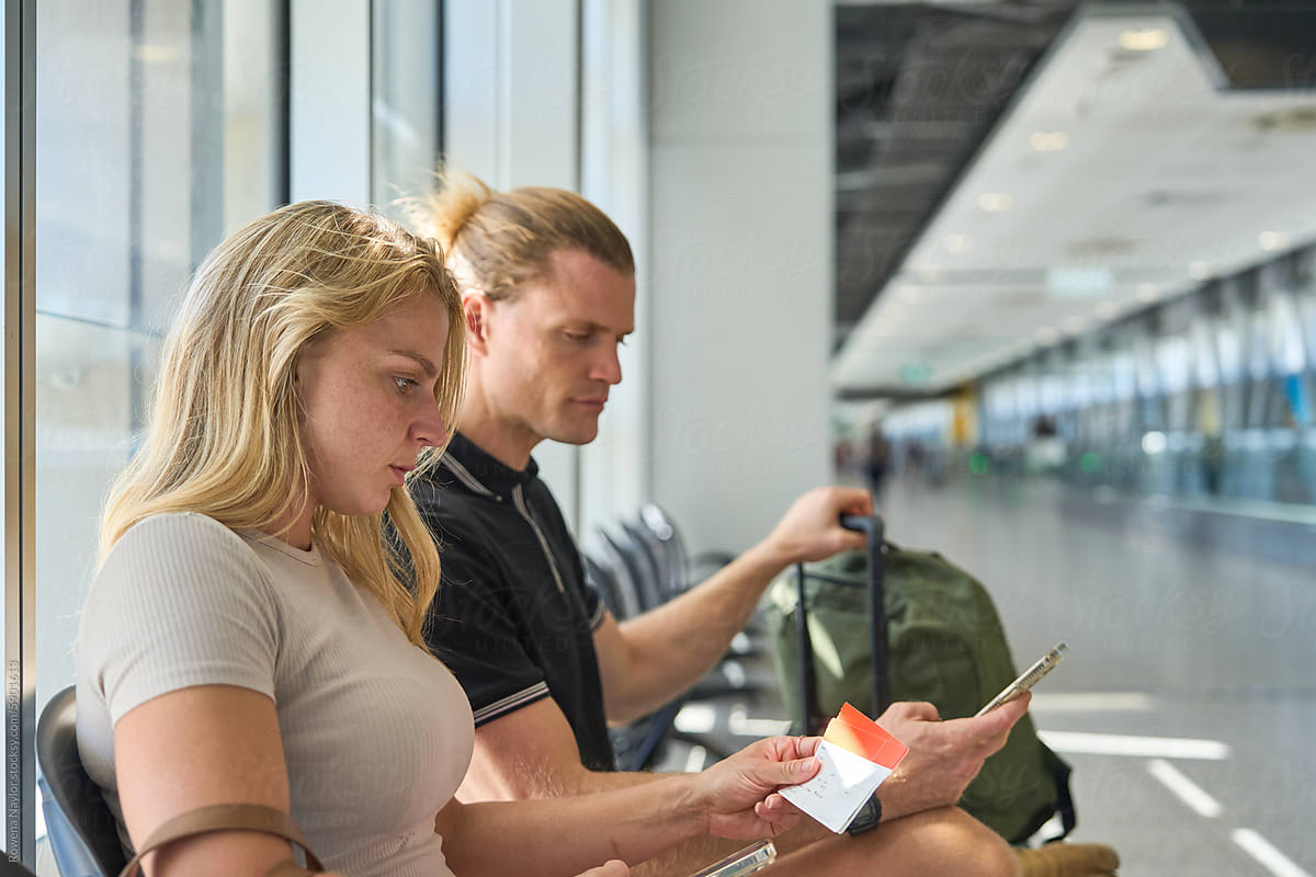 Couple at airport waiting for flight departure