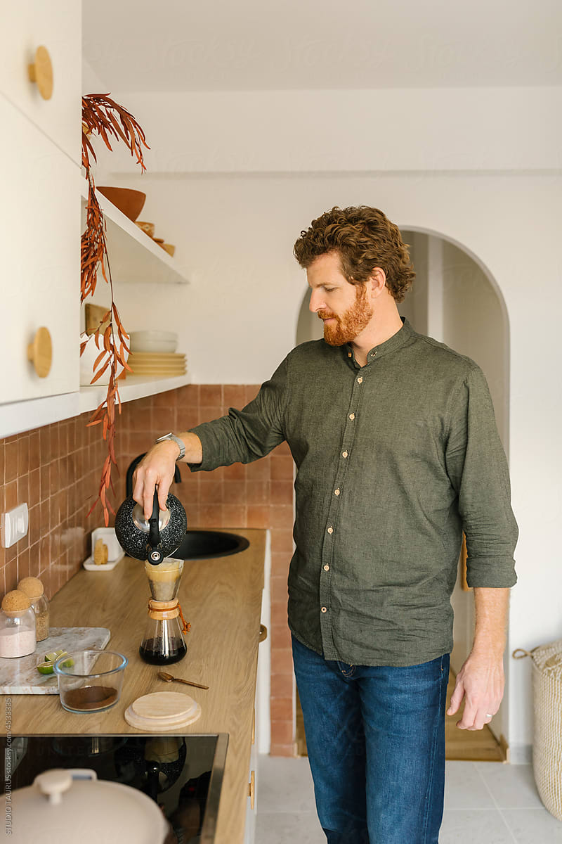 Bearded man in the kitchen preparing coffee