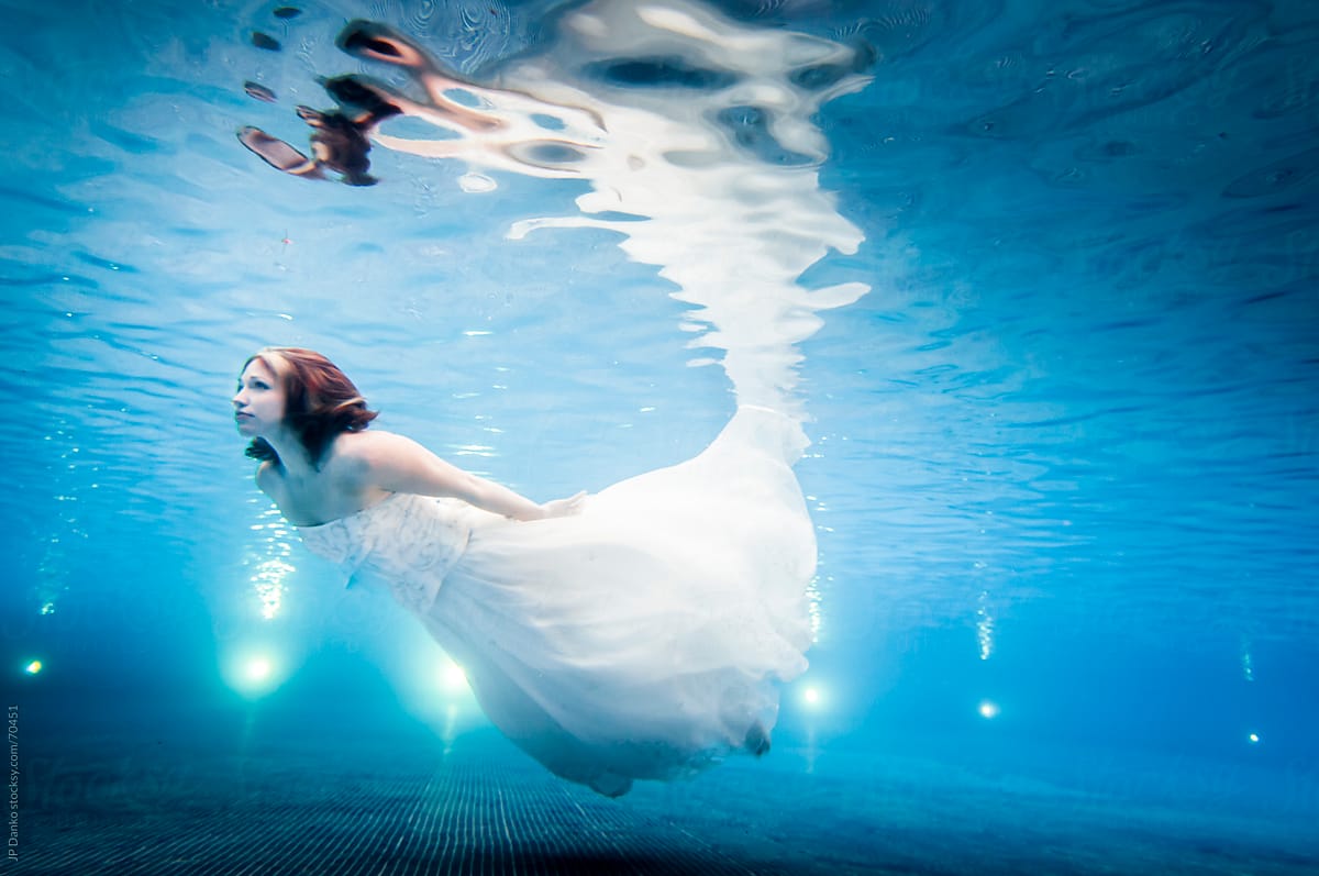 Trash the Dress Underwater Bride Swimming in Wedding Dress to Surface