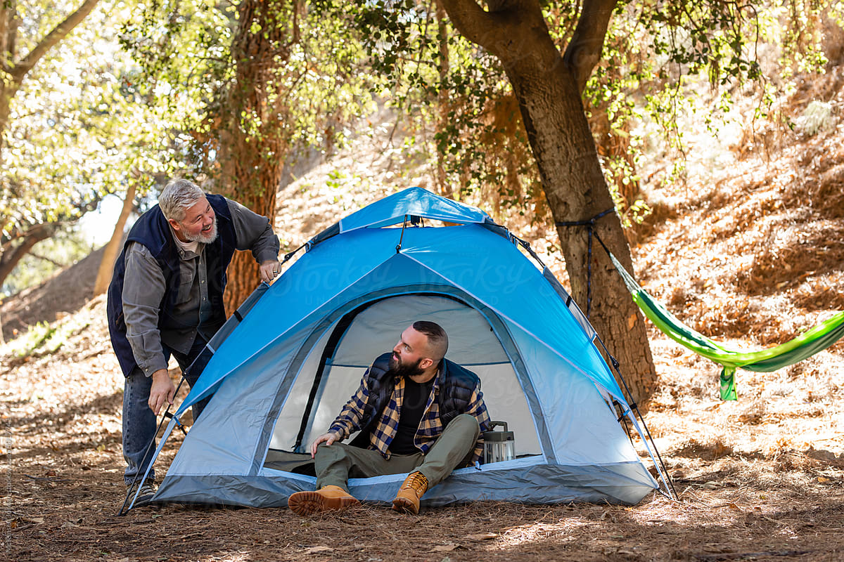 Two Bearded Men Happily Set Up Their Campsite In The Woods