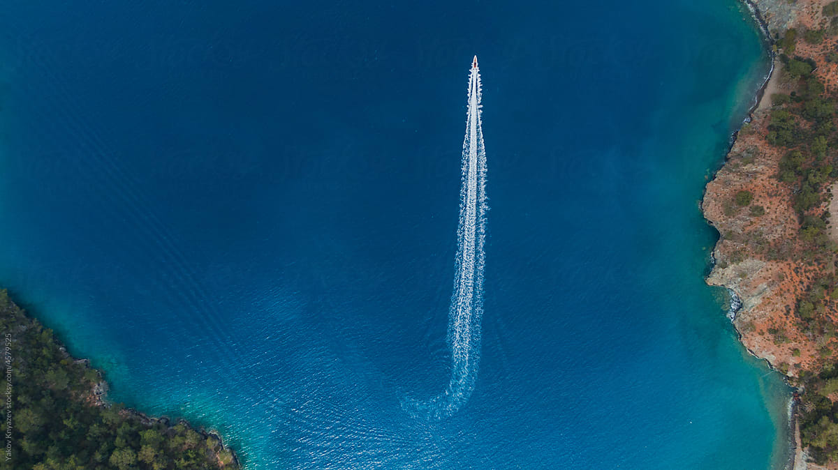 drone view of a speedboat in azure water