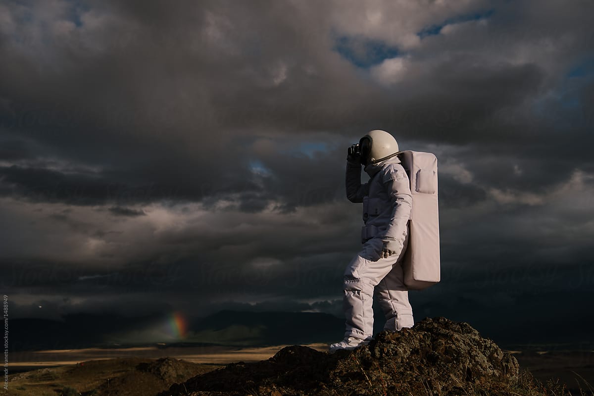 Man in spacesuit posing on landscape
