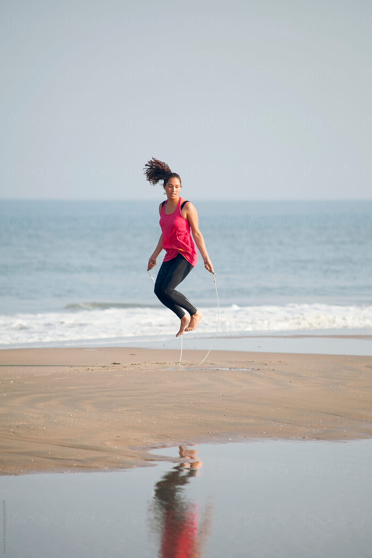 Healthy Woman Works Out With Jump Rope On The Beach Del Colaborador De Stocksy Denni Van