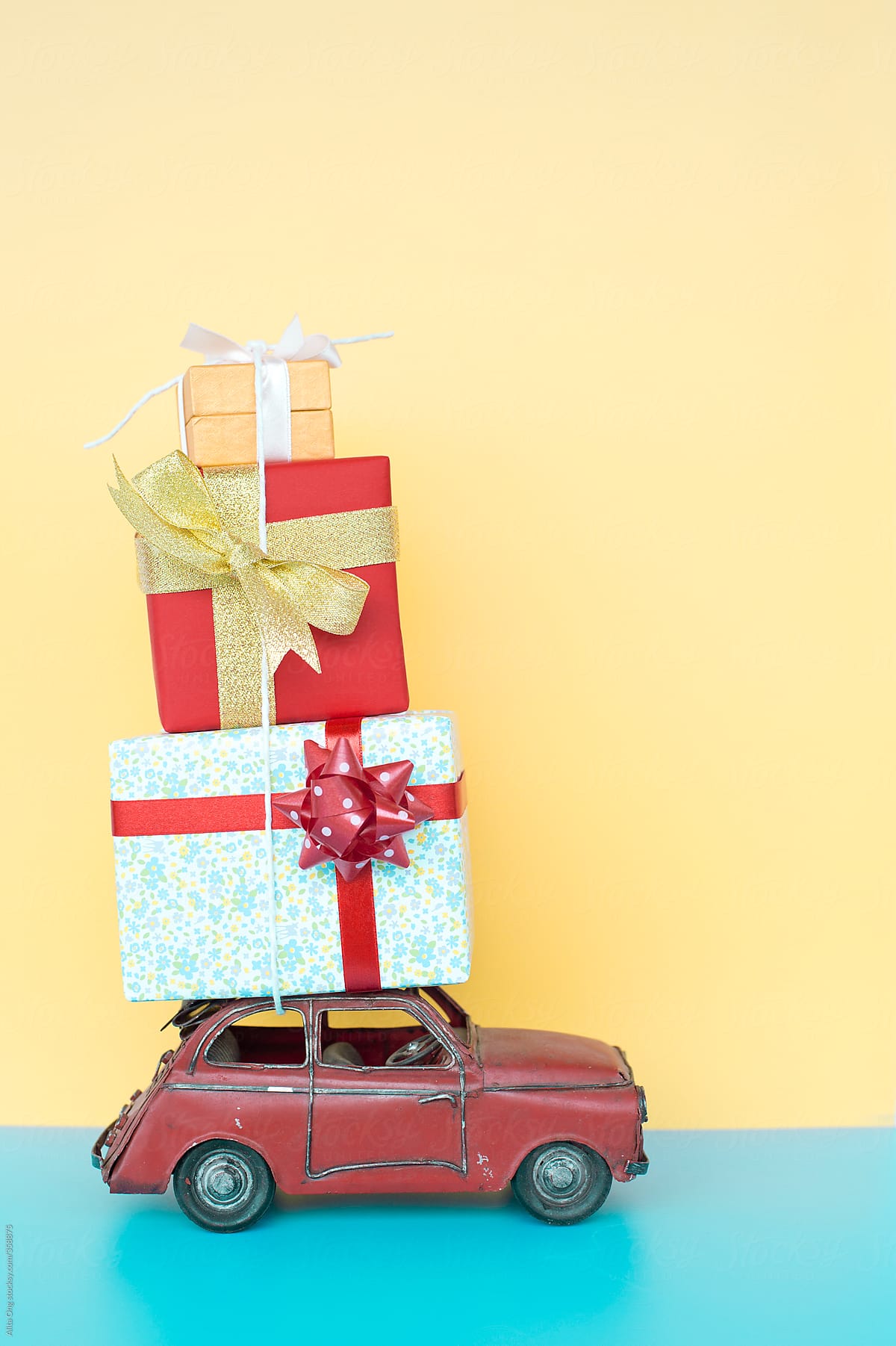 Three colorful gift boxes on vintage car