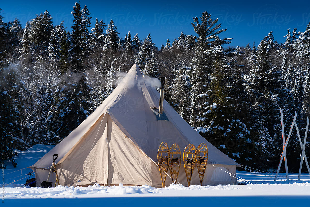 Traditional Canvas Tent Snowshoes and Skis on Wilderness Frozen
