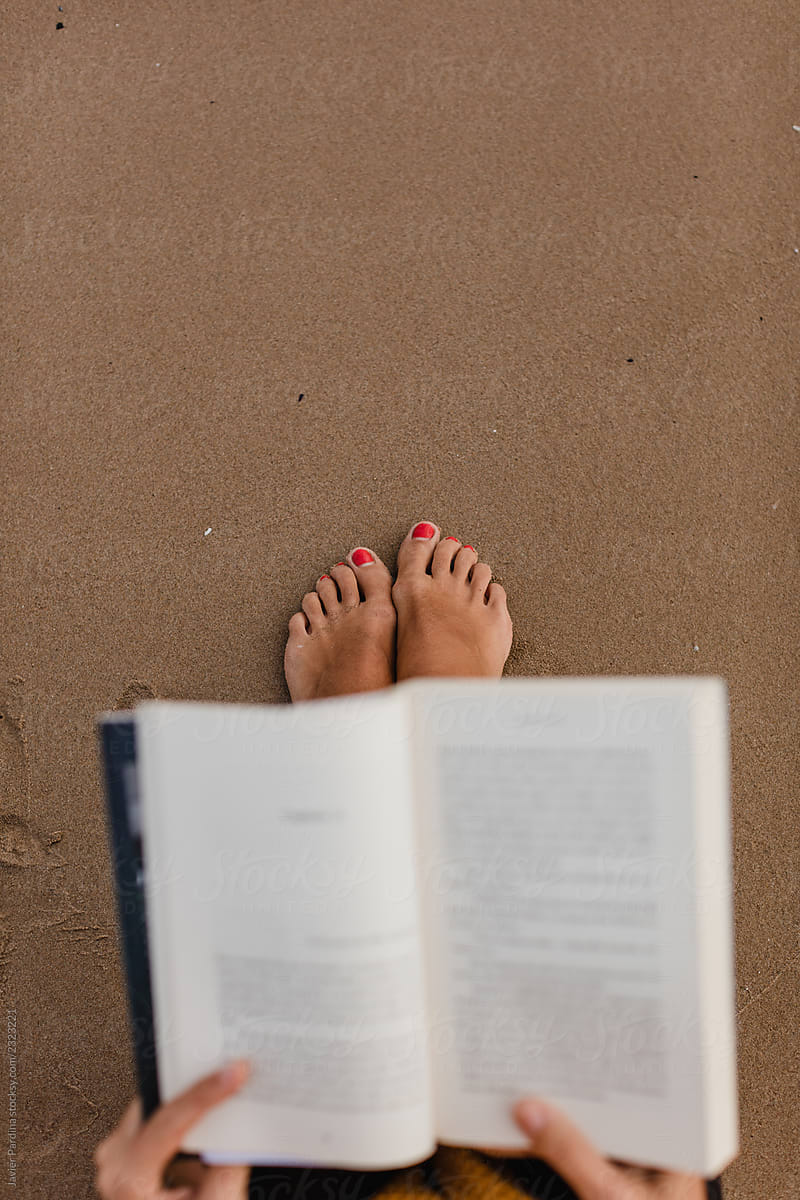 reading a book on the sand