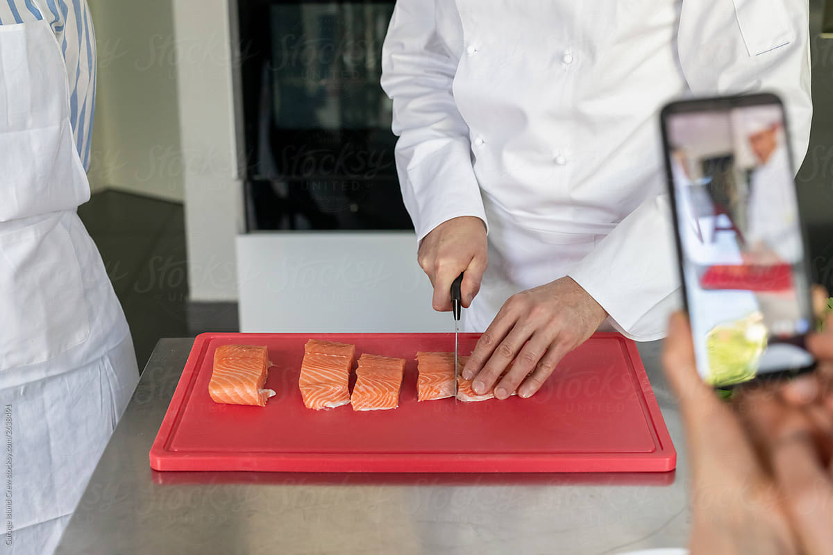 Chef cutting salmon during a kitchen class