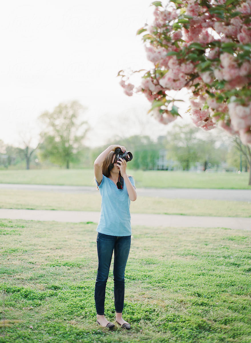 Young Teen Girl Taking Pictures Of Cherry Blossom Flowers By Marta