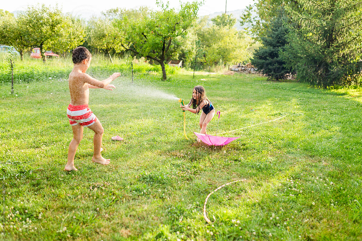 Children playing with garden hose