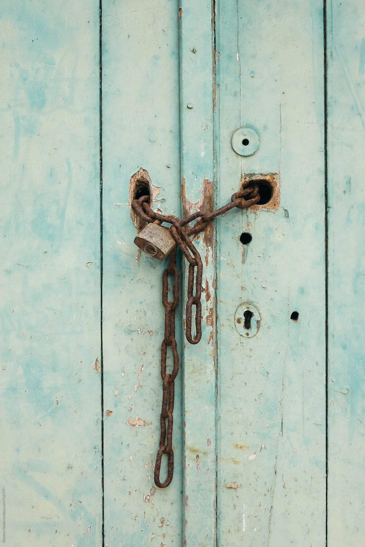 Old rusty chain and lock on shed door