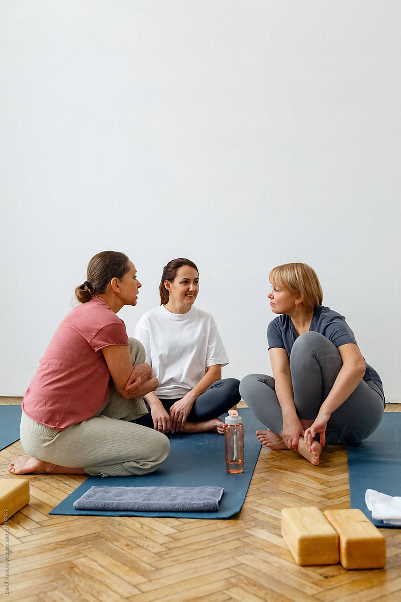 Company of women talking during yoga lesson