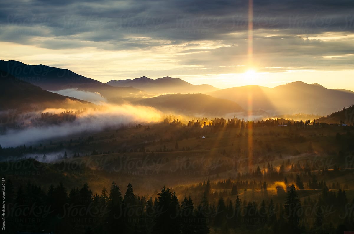 Sunset over fairy tale landscape with fog