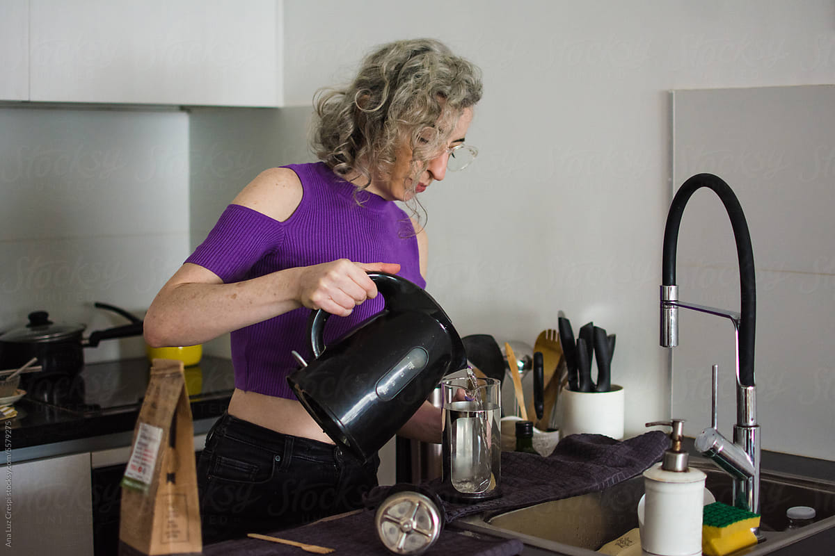 Woman with grey hair starting to make coffee