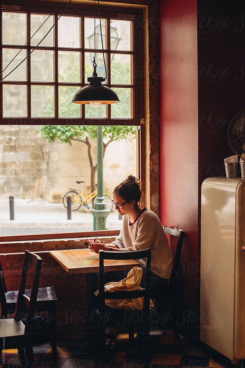 Girl Sitting In A Cafe By Stocksy Contributor Aila Images Stocksy