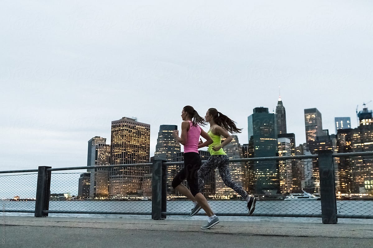 Young women jogging in New York City at twilight