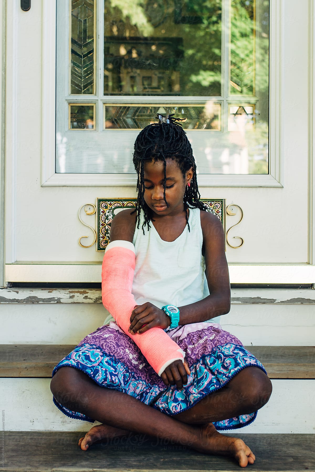 Black Girl Looking At Her Pink Cast By Stocksy Contributor Gabi