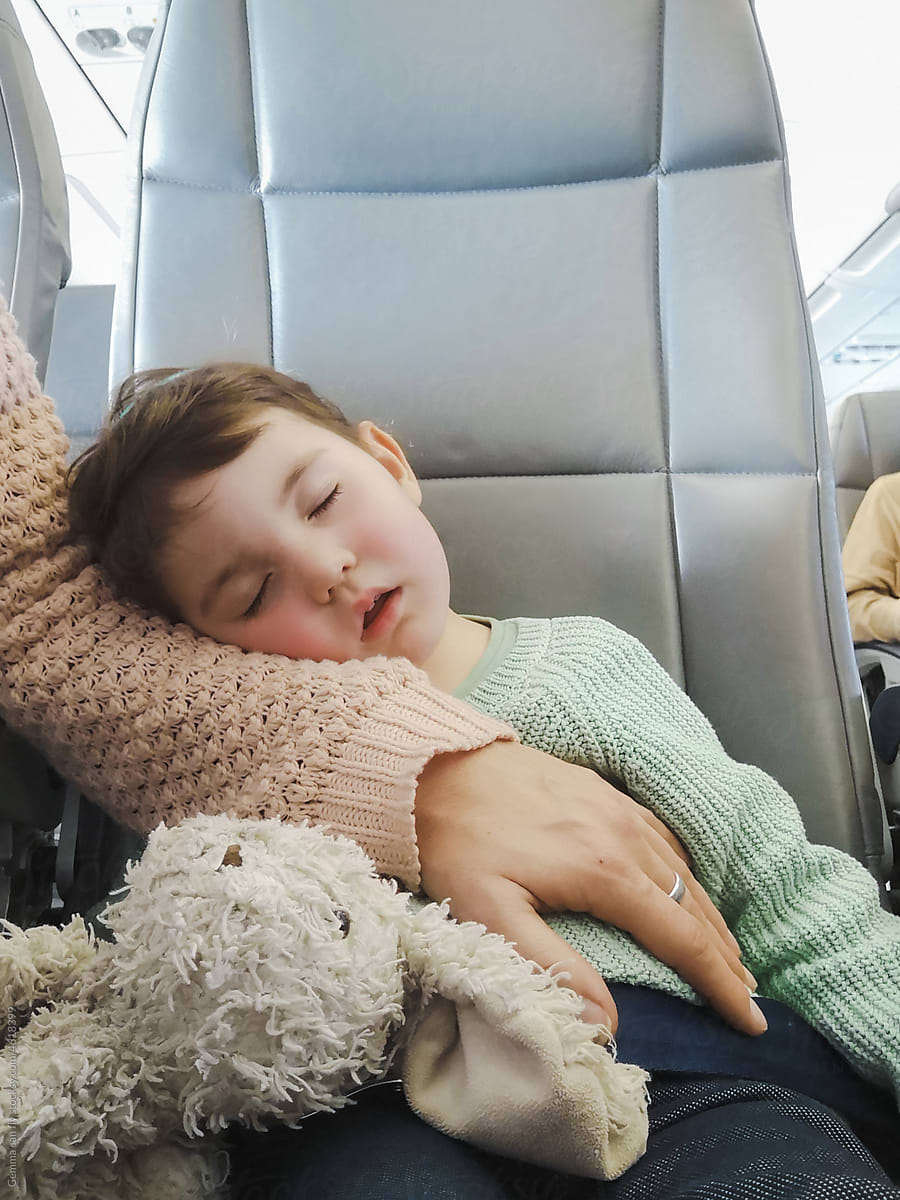 Little girl sleeping on plane. Travel UGC, user-generated content.