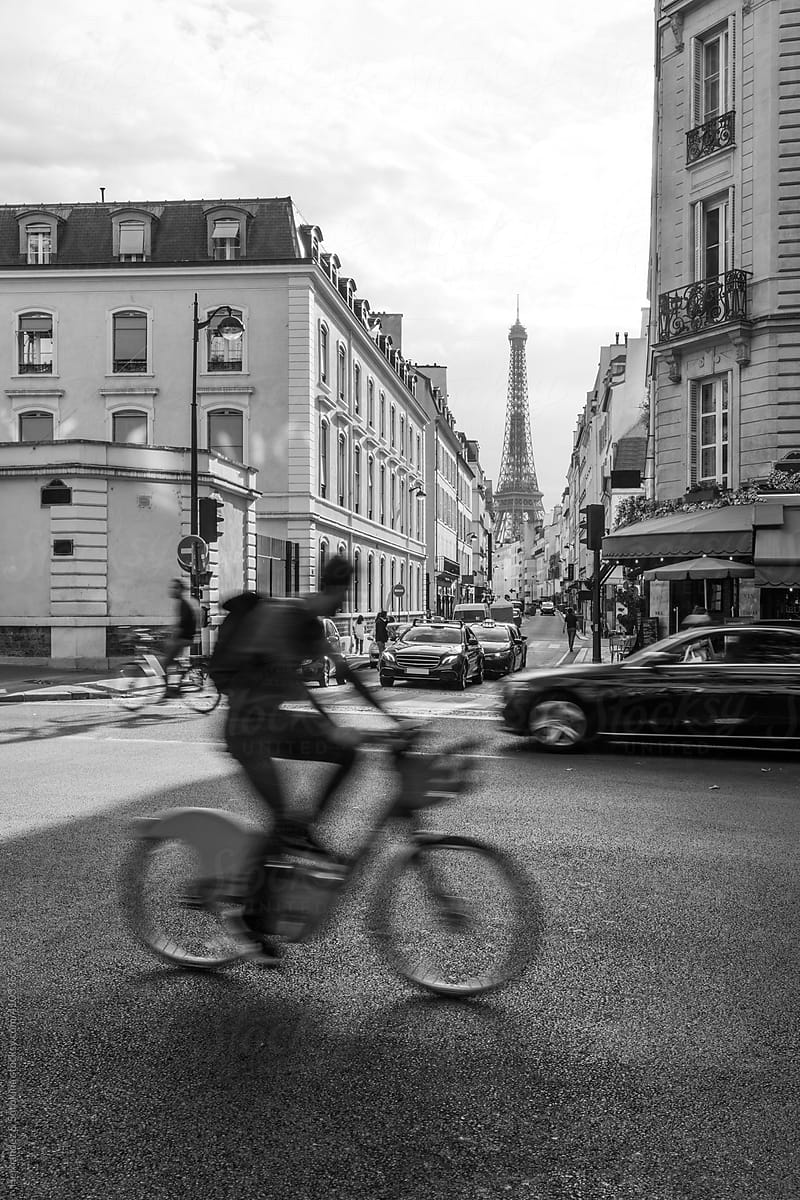 Cyclist Crossing Street With Eiffel Tower View