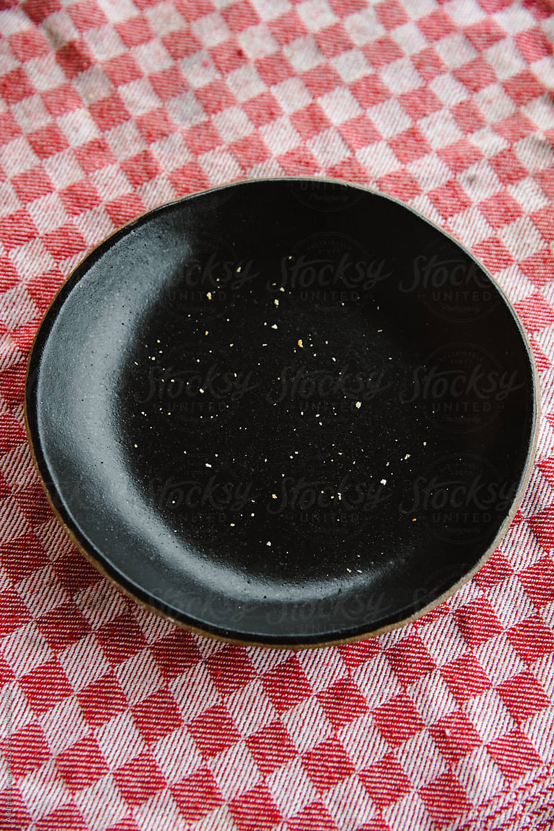 Black ceramic plate with bread crumbs