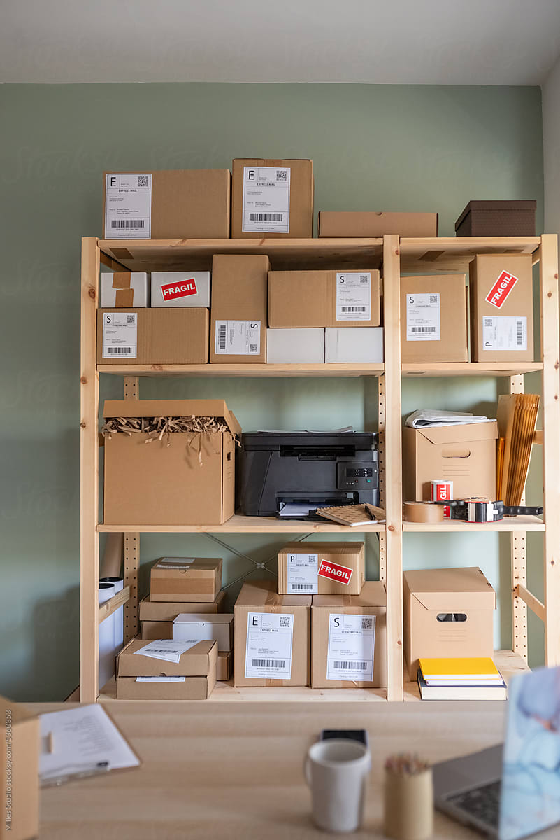 Shelves with parcels and printer in office